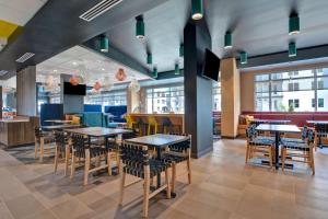 a dining area with tables and chairs in a restaurant at Tru By Hilton St. Petersburg Downtown Central Ave in St. Petersburg