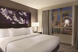 a bedroom with a large white bed and a window at Embassy Suites by Hilton Atlanta at Centennial Olympic Park in Atlanta