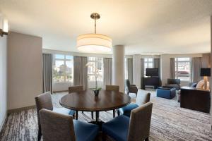 a living room with a table and chairs at Embassy Suites by Hilton Atlanta at Centennial Olympic Park in Atlanta
