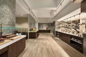 a large kitchen with wooden floors and counters at Embassy Suites San Antonio Brooks City Base Hotel & Spa in San Antonio