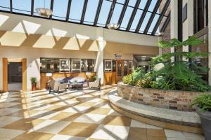 an indoor lobby with a glass ceiling and plants at DoubleTree by Hilton Jackson in Jackson