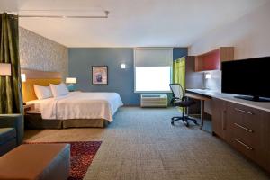 欧克莱尔Home2 Suites Eau Claire South, Wi的配有床和书桌的酒店房间