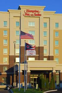 a hotel with two flags in front of it at Hampton Inn & Suites Columbus/University Area in Columbus