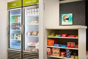 a store refrigerator filled with lots of food and drinks at Home2 Suites By Hilton Pensacola I-10 Pine Forest Road in Pensacola