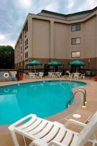 a pool at a hotel with chairs and umbrellas at Hampton Inn Downingtown/Exton in Exton