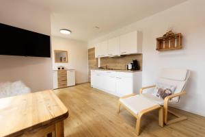 a living room with a table and a kitchen at Chalet Winterberg in Winterberg
