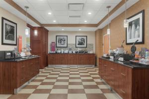 a dental office with wooden cabinets and a checkered floor at Hampton Inn & Suites Macon I-75 North in Macon
