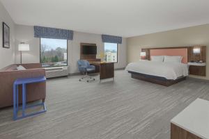 a hotel room with a bed and a desk at Hampton Inn & Suites Macon I-75 North in Macon