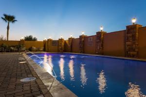 a swimming pool at night with the lights on at Hampton Inn & Suites Mission in Mission