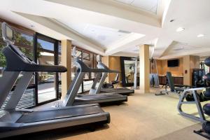 a fitness room with treadmills and elliptical machines at Hilton Stockton in Stockton