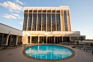 a large building with a swimming pool in front of a building at DoubleTree by Hilton Midland Plaza in Midland