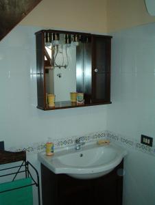 a bathroom with a sink and a mirror at Saline in Favignana