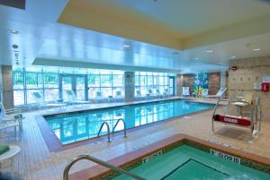 een groot zwembad in een groot gebouw bij Hilton Garden Inn Rockville - Gaithersburg in Rockville