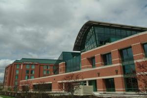 a large brick building with a sign on it at Hampton by Hilton Ottawa in Ottawa