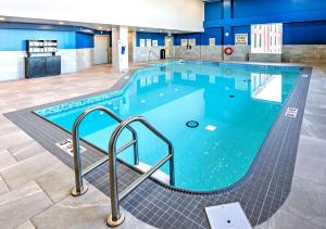 a large swimming pool with blue water at Hampton by Hilton Ottawa in Ottawa