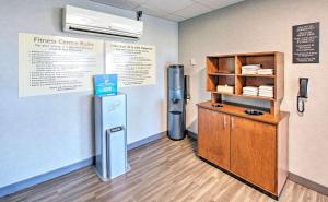 a room with a refridgerator next to a shelf at Hampton by Hilton Ottawa in Ottawa