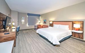 a hotel room with a bed and a flat screen tv at Hampton by Hilton Ottawa in Ottawa