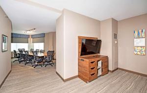 a conference room with a television and a table with chairs at Hampton by Hilton Ottawa in Ottawa