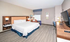 a hotel room with a bed and a flat screen tv at Hampton by Hilton Ottawa in Ottawa