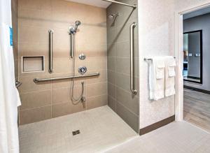 a bathroom with a shower with white towels at Hampton by Hilton Ottawa in Ottawa