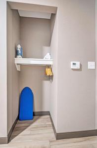 a room with a blue chair and a shelf at Hampton by Hilton Ottawa in Ottawa