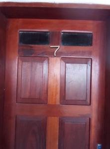 a wooden door with a number on it at Caju Hostel in Alter do Chao