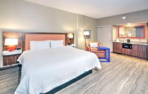a hotel room with a large bed and a kitchen at Hampton by Hilton Ottawa in Ottawa