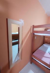 a mirror in a room with a bunk bed at Caju Hostel in Alter do Chao