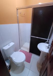 a bathroom with a toilet and a shower and a sink at Caju Hostel in Alter do Chao