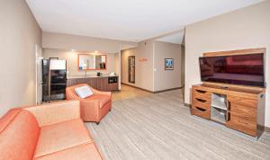 a living room with a couch and a flat screen tv at Hampton by Hilton Ottawa in Ottawa
