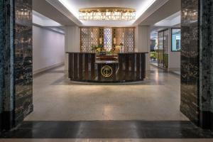 a lobby with a reception desk in the middle of a building at Tulsa Club Hotel Curio Collection By Hilton in Tulsa