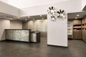 a lobby with a chandelier and a wall at Homewood Suites Williamsburg in Williamsburg