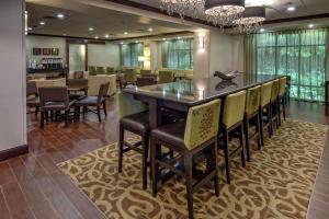 a bar in a restaurant with chairs and tables at Hampton Inn Cambridge in Cambridge