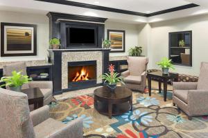 a living room with a fireplace and a tv at Hampton Inn Columbia I-20-Clemson Road in Columbia