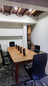 a conference room with a wooden table and chairs at Rest&Relax Villa in Johannesburg