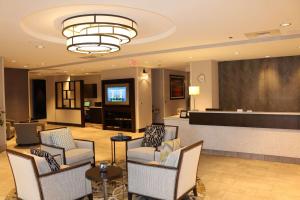 a lobby of a hotel with chairs and a bar at Doubletree By Hilton Raleigh Crabtree Valley in Raleigh