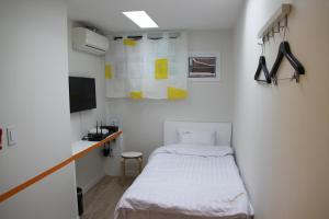 Ένα ή περισσότερα κρεβάτια σε δωμάτιο στο Starhostel Dongdaemun Suite