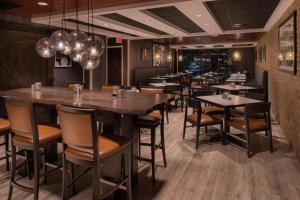 a restaurant with tables and chairs in a room at Doubletree By Hilton Raleigh Crabtree Valley in Raleigh