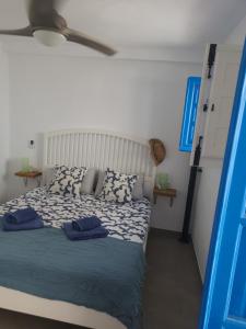 a bedroom with a bed with two pillows on it at Casa mi sùeño azul in Torrox +23 photos