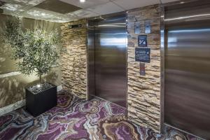 a elevator in a lobby with a potted plant on the floor at Hampton Inn by Hilton San Diego - Kearny Mesa in San Diego