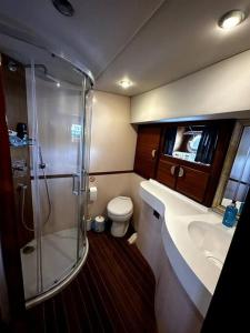 a bathroom with a shower and a sink and a toilet at Bodrum Private Yacht Rental in Bodrum City