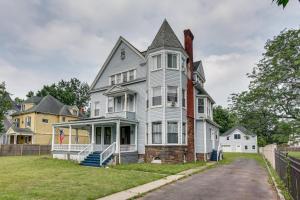 a large white house with a turret at Updated Apartment Near New York City! in East Orange