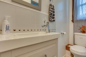 a white bathroom with a sink and a toilet at Updated Apartment Near New York City! in East Orange