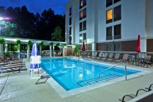 a swimming pool in front of a hotel at night at Hampton Inn Atlanta-Northlake in Atlanta