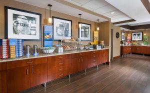 a cafeteria with a counter with food on it at Hampton Inn Mansfield/Ontario in Mansfield