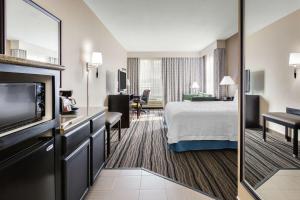Hampton Inn & Suites Mountain View في ماونتن فيو: غرفه فندقيه سرير وتلفزيون