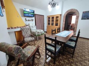 a living room with a dining room table and chairs at Sagittario House in Torre delle Stelle