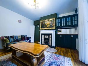 a living room with a table and a fireplace at Cozy flat near Kings Cross in London