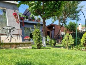 a house with a bench in the yard at Guest House Simon Green in Balchik