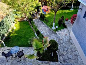 an aerial view of a garden with tables and chairs at Guest House Simon Green in Balchik